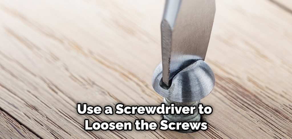 Use a Screwdriver to Loosen the Screws