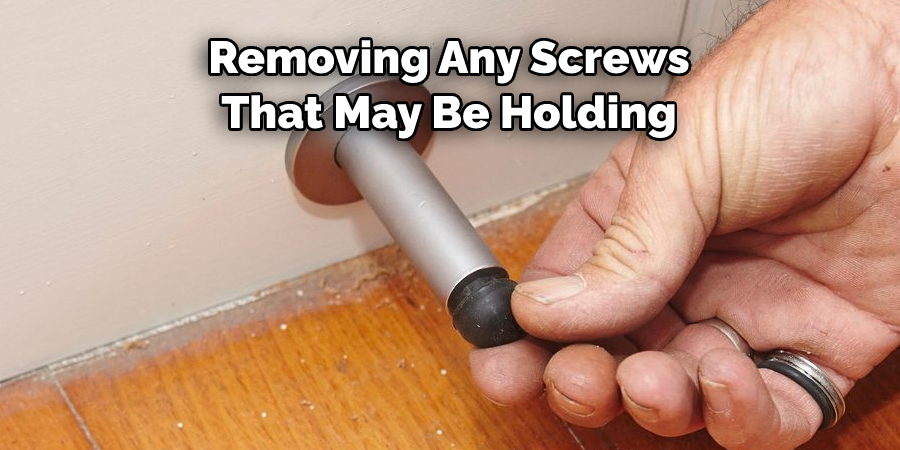 Removing Any Screws 
That May Be Holding 