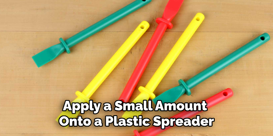 Apply a Small Amount Onto a Plastic Spreader
