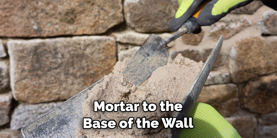 Mortar to the Base of the Wall