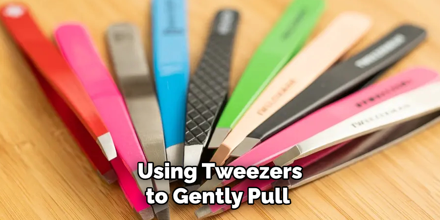 Using Tweezers to Gently Pull 