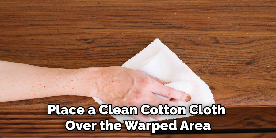 Place a Clean Cotton Cloth 
Over the Warped Area