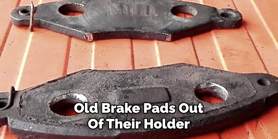 Old Brake Pads Out 
Of Their Holder 